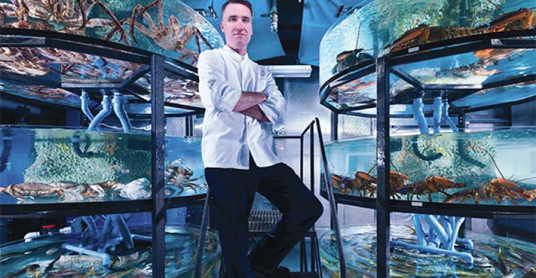 Resort executive chef Thomas Connell stands in ldquowater worldrdquo where fresh fish are stored in tanks until they are cooked