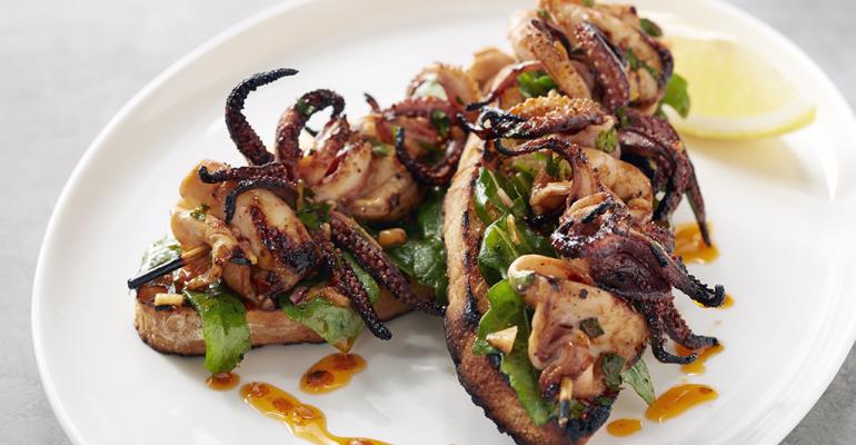 Charred Squid Skewers with Chermoula Marinade on Garlic Toast with Arugula
