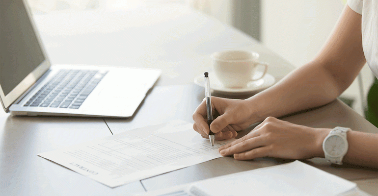 woman-filling-out-business-loan-paperwork.gif
