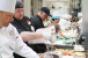 Chef Kenneth Danko second from left of Devilicious in Temecula CA prepares his signature lobster roll on a 50foot line kitchen outside the NYSE last Thursday