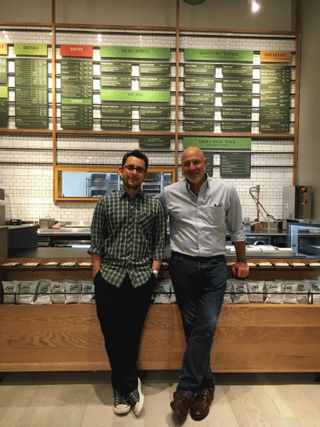’Wichcraft co-founders Sisha Ortuzar and Tom Colicchio stand in front of the new menu board.